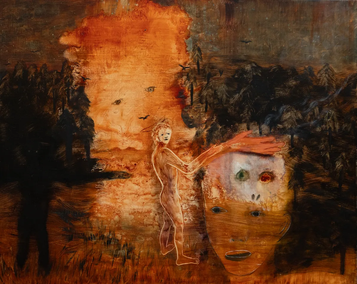 Full view: a spectral figure and a large face on a burning orange ground with a dark treeline