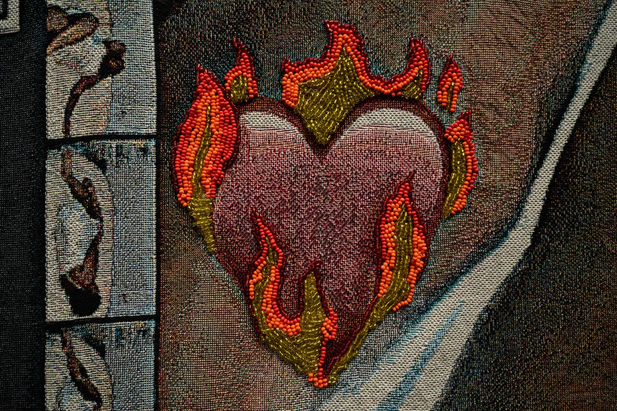 Detail of the beaded flaming heart sewn onto the chest