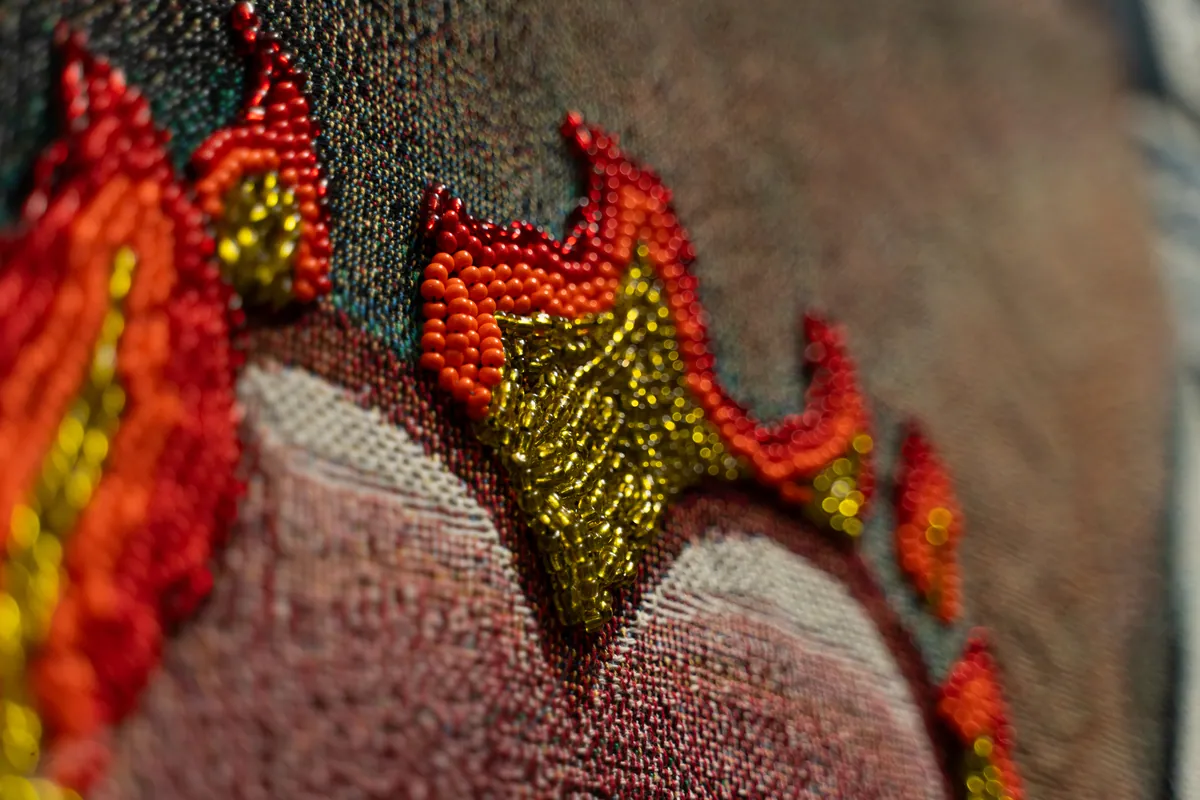 Macro detail of glass seed beads worked into the flames
