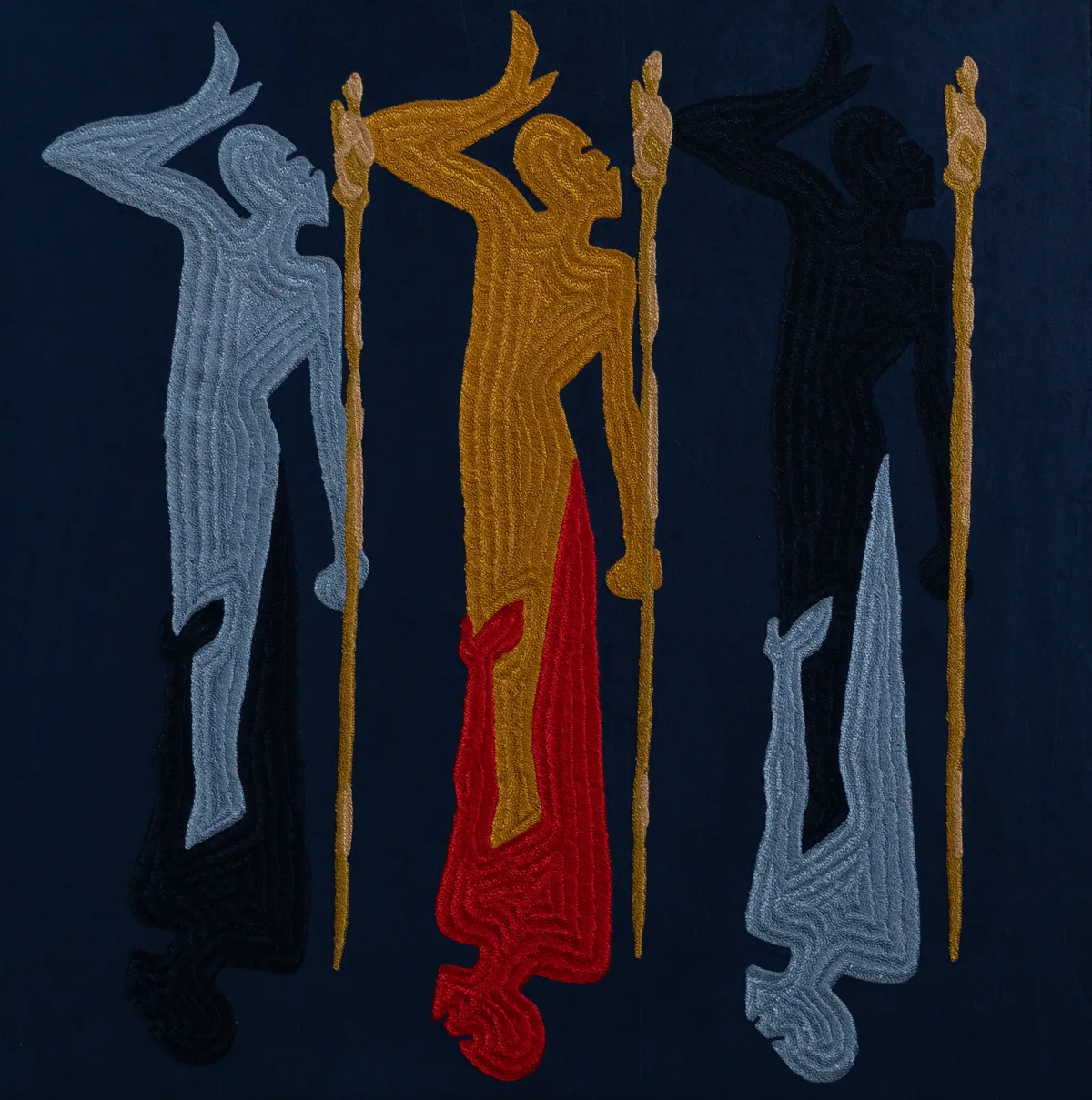 Full view: five embroidered figures with staffs on deep indigo velvet, one figure inverted in red