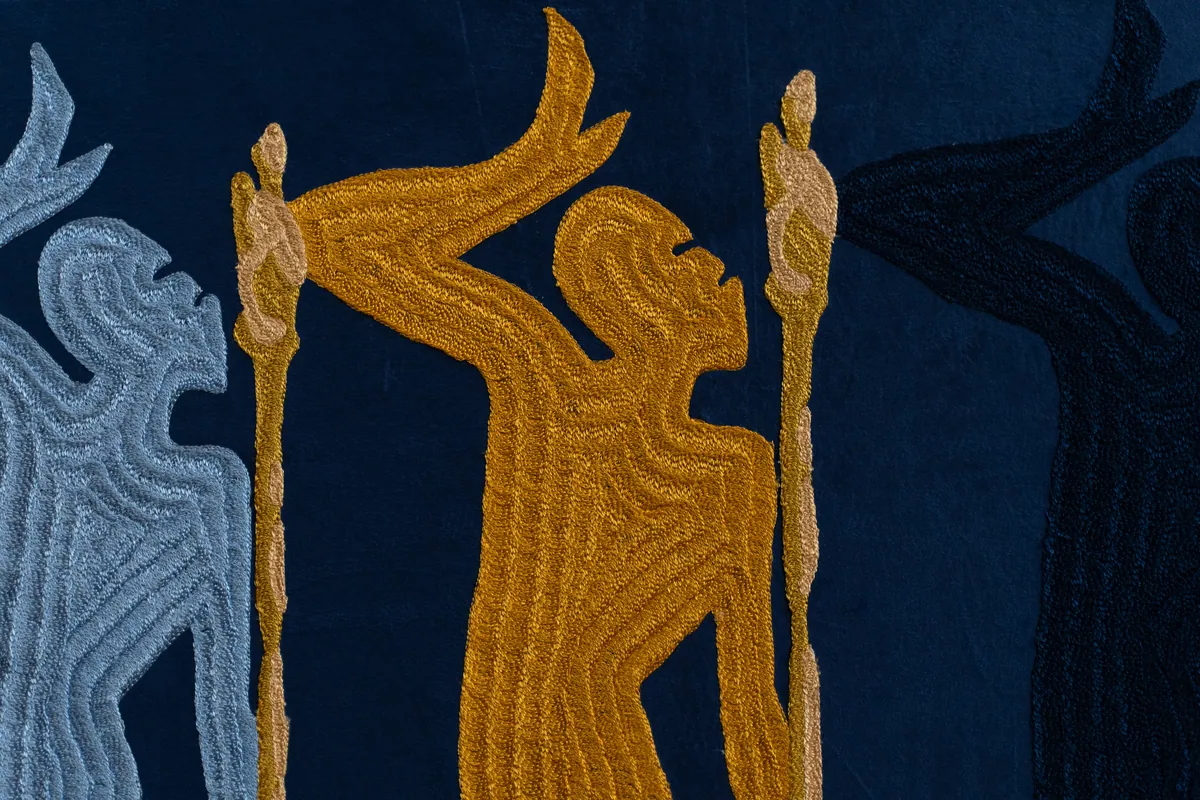 Detail of the gold and pale blue figures and their staffs